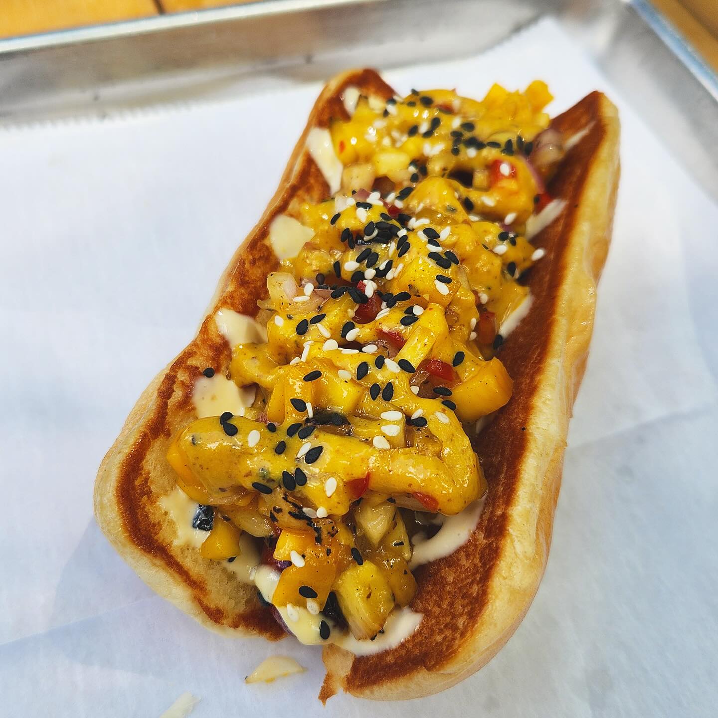 Sausage with mango salsa topping